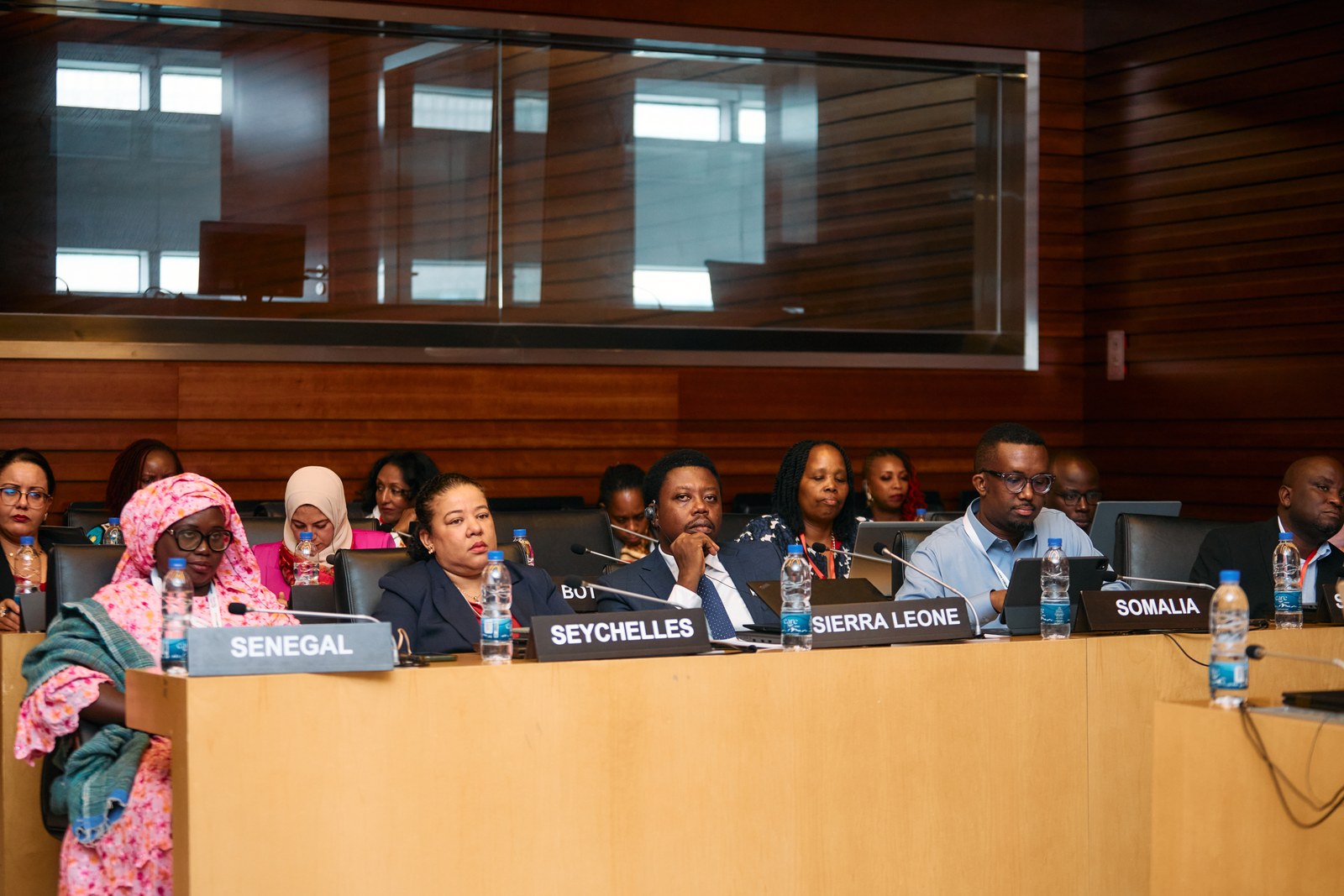 Member State delegations seated behind country nameplates during a session of the Africa Care Forum