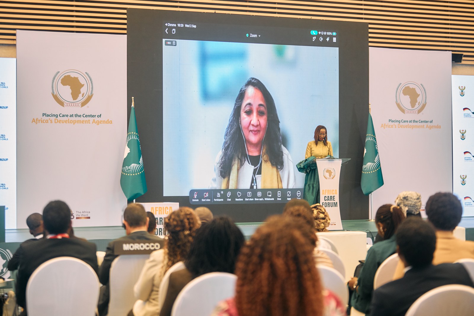 Delegates watching a virtual address on screen during a plenary session at the Africa Care Forum