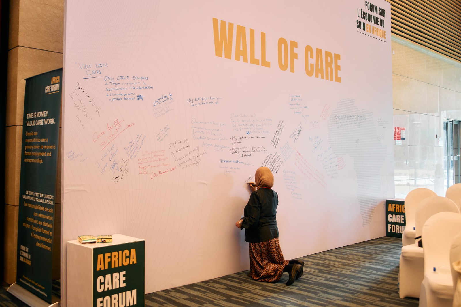 Delegate writing a message on the Wall of Care at the Africa Care Forum in Addis Ababa